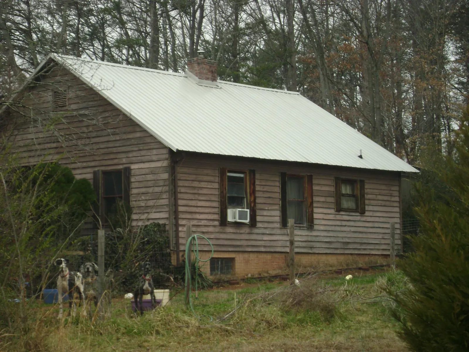 White metal roof on an old wood sided farmhouse, from a Metal Roof Installation job in Sweetwater